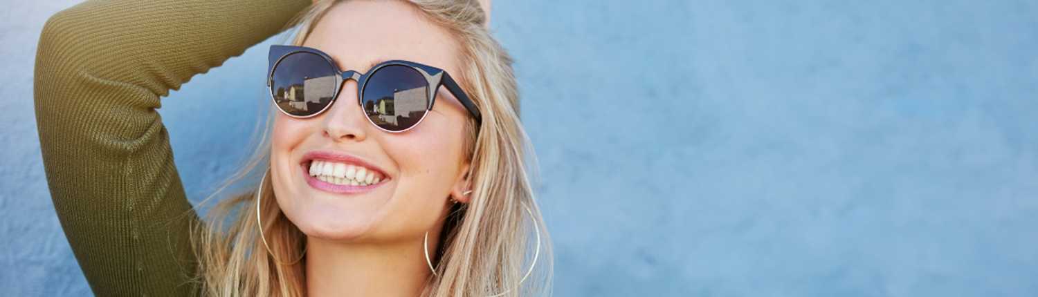 A woman with sunglasses smiling